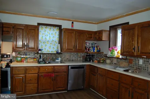 a kitchen with a sink a stove and cabinets