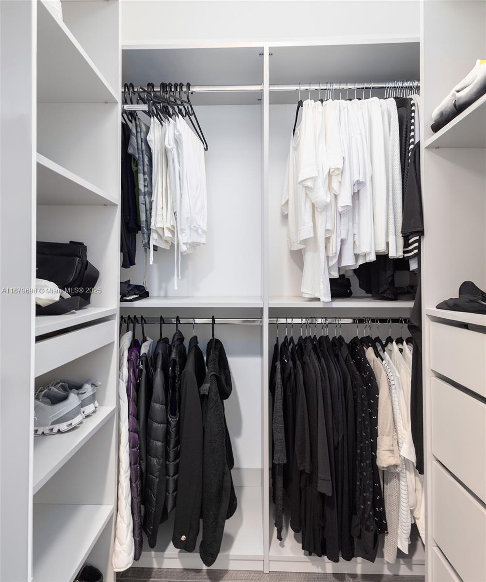 90 Alton Road, Unit 1703 Miami Beach, FL 33139 - Photo 13 of 48 a view of walk in closet with clothes and shoes