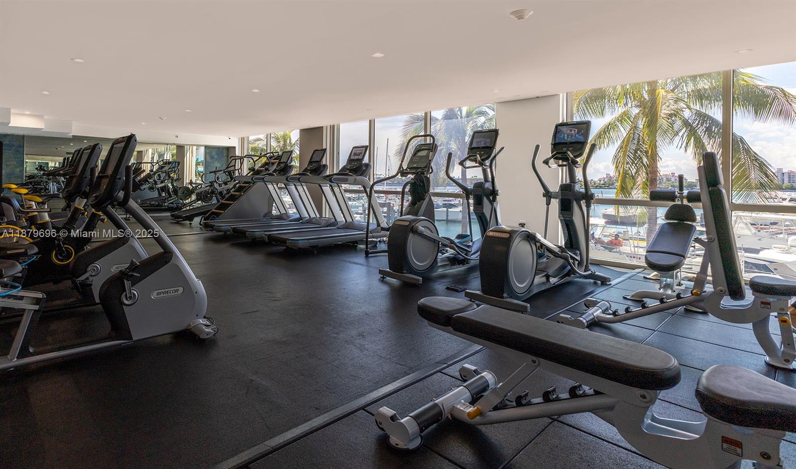 90 Alton Road, Unit 1703 Miami Beach, FL 33139 - Photo 27 of 48 a room with gym equipment and a large window