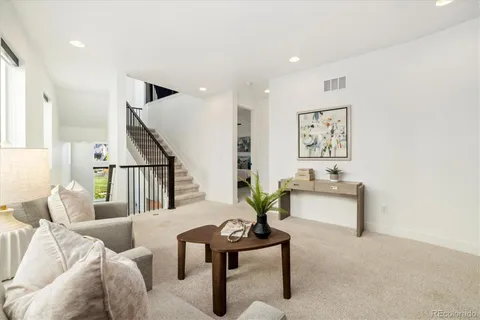 a view of a dining room with furniture and a chandelier