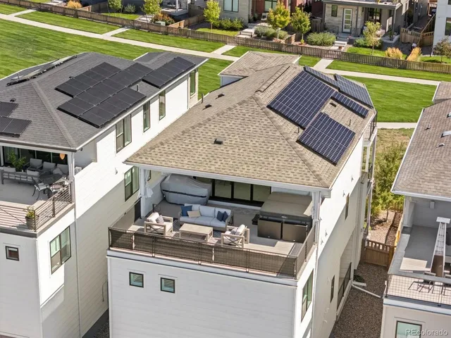 a view of a patio with table and chairs and a barbeque