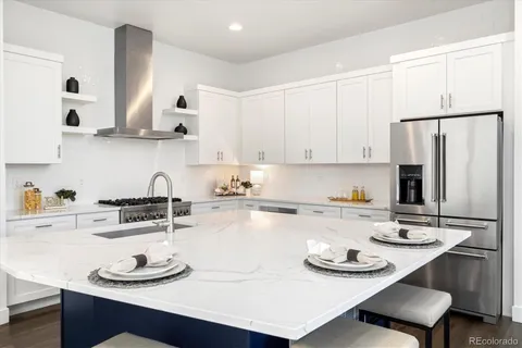a kitchen with stainless steel appliances a sink a stove and refrigerator
