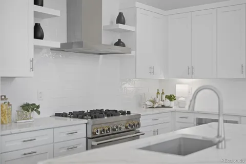 a kitchen with white cabinets and appliances
