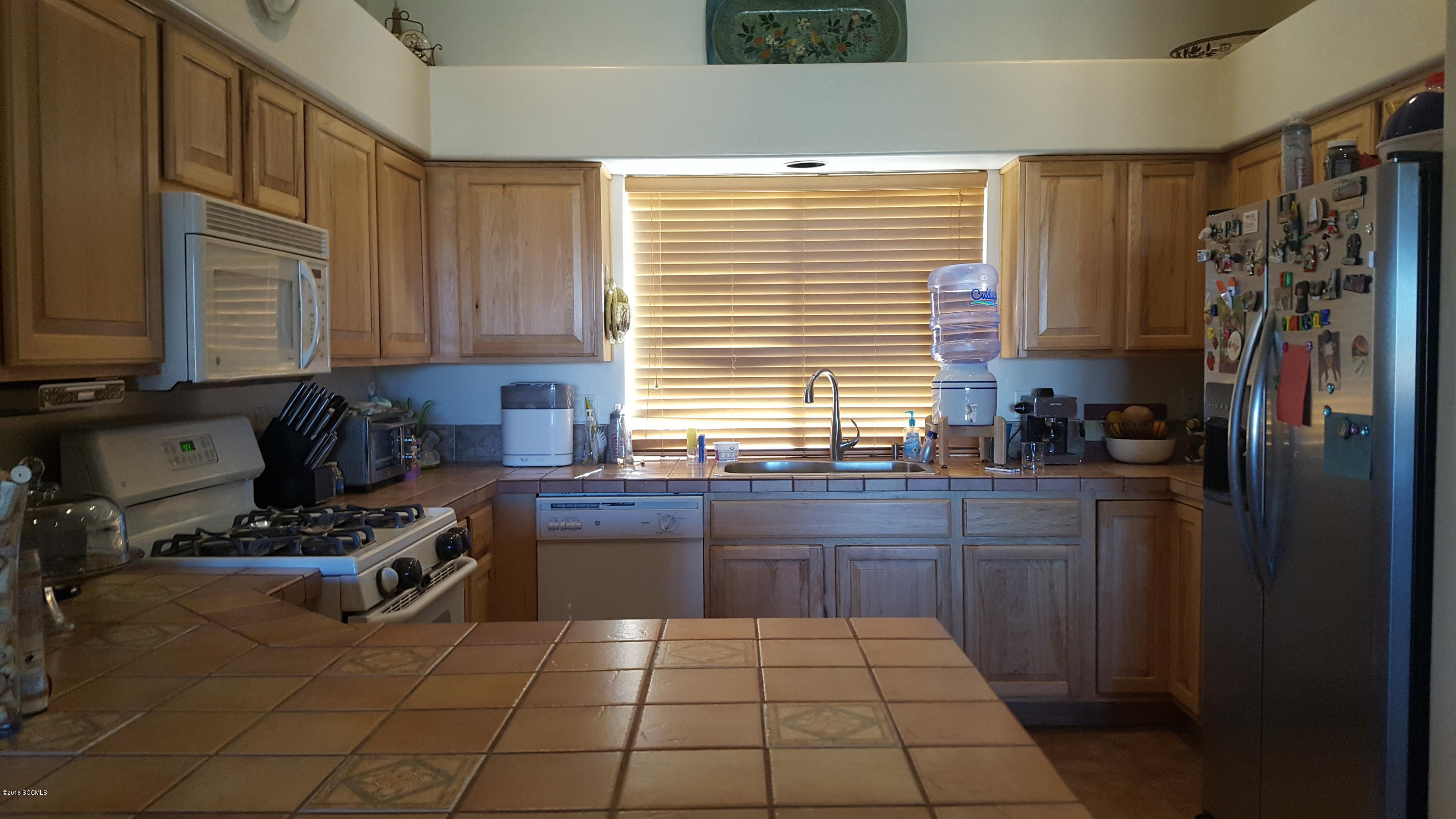 304 Circulo Bellagio Rio Rico, AZ 85648 - Photo 3 of 19 a kitchen with granite countertop a stove a sink and a refrigerator