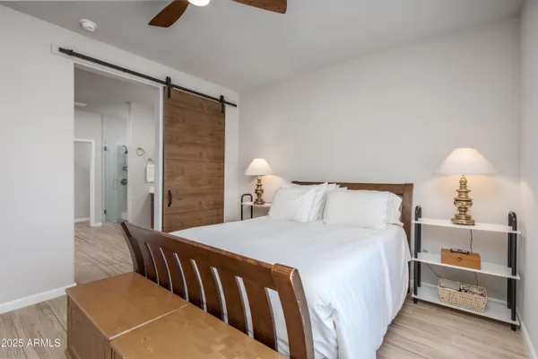 a bedroom with a bed and a lamp