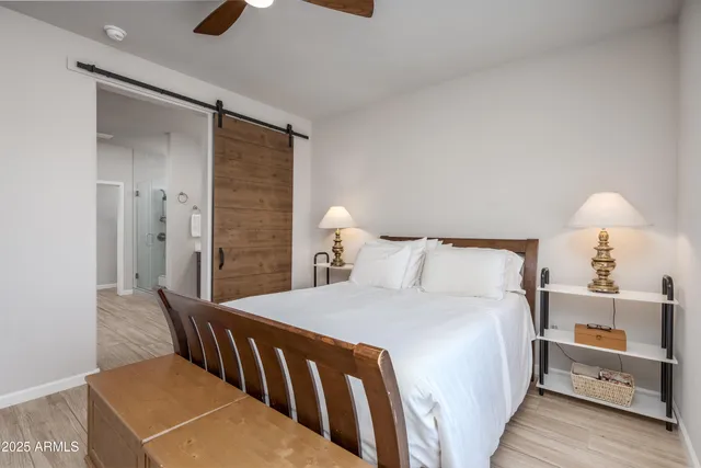 a bedroom with a bed and a lamp