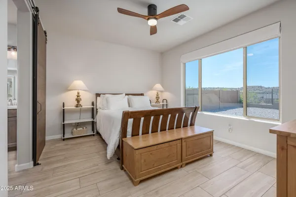 a bedroom with furniture and a window