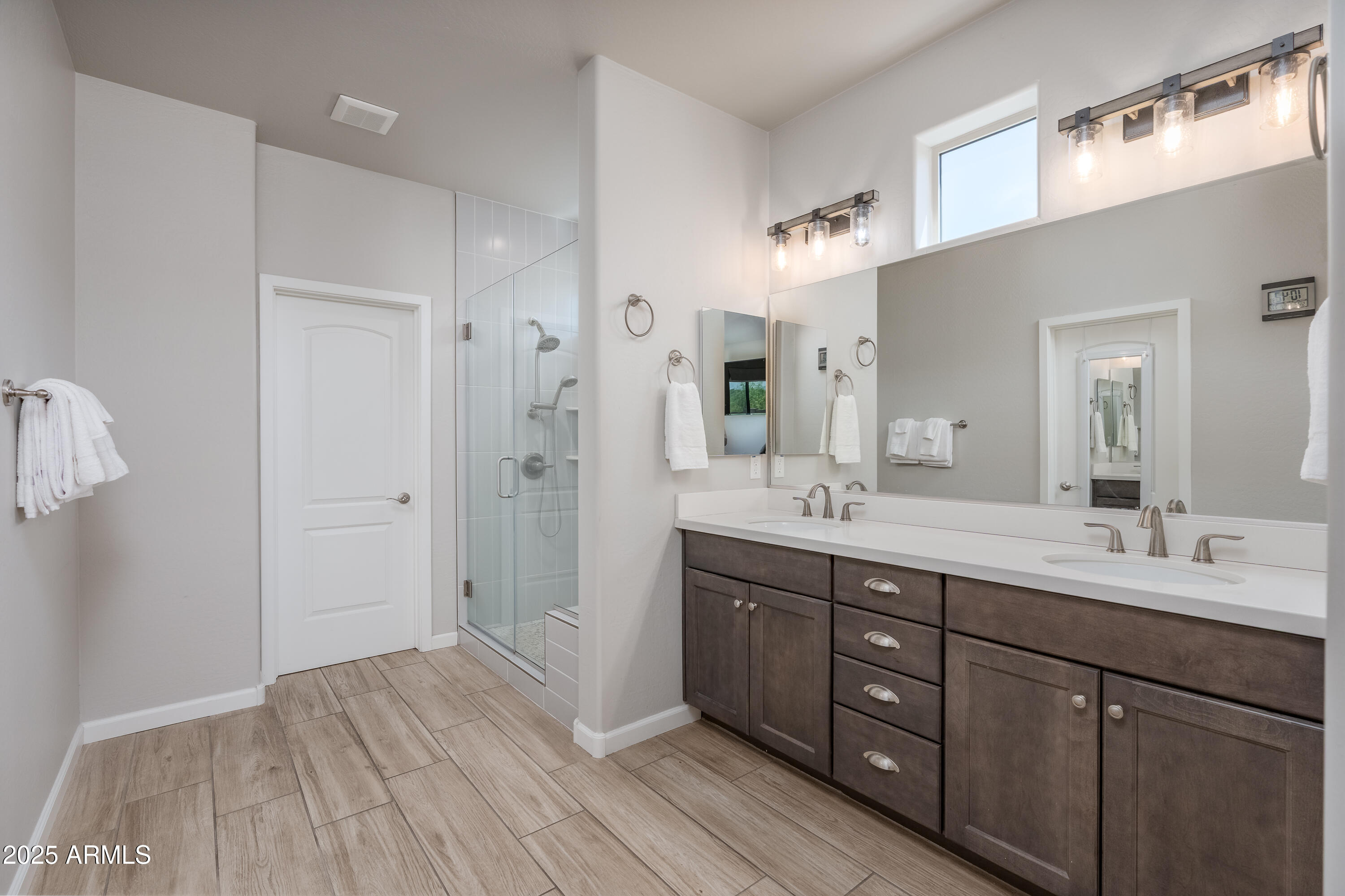 439 McKinnon Road Clarkdale, AZ 86324 - Photo 14 of 39 a spacious bathroom with a double vanity sink a mirror and a shower