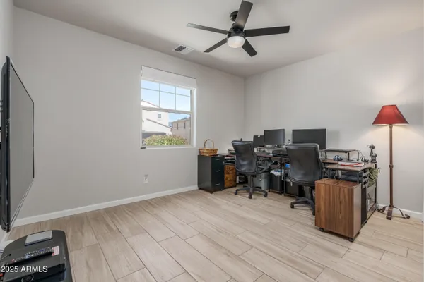 a view of a workspace with furniture and a window