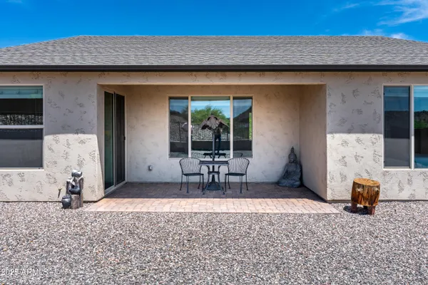 a backyard of a house with table and chairs