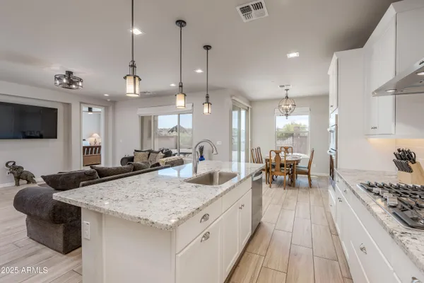 a kitchen with sink stove and cabinets
