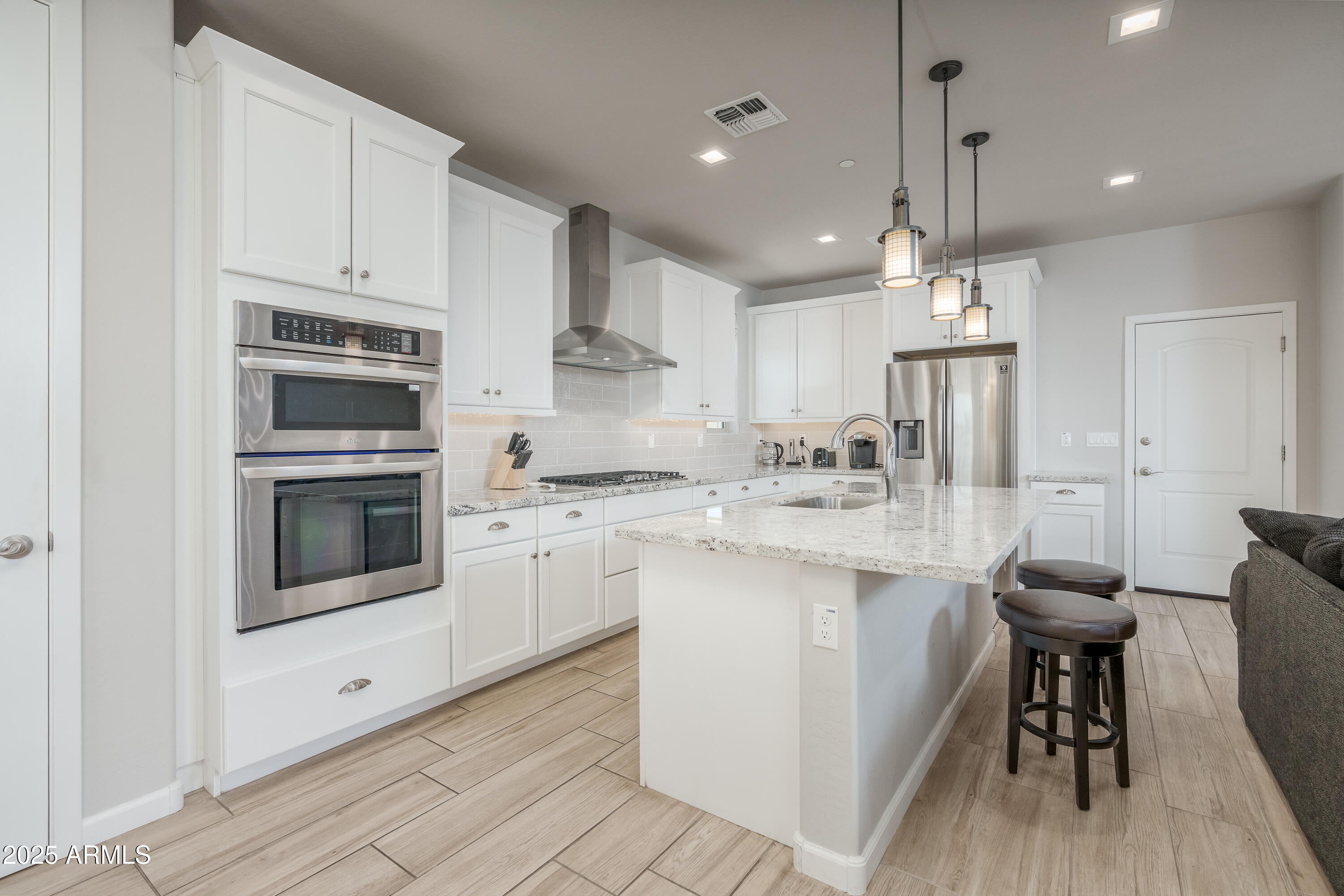 439 McKinnon Road Clarkdale, AZ 86324 - Photo 9 of 39 a kitchen with kitchen island a white counter top space cabinets and stainless steel appliances
