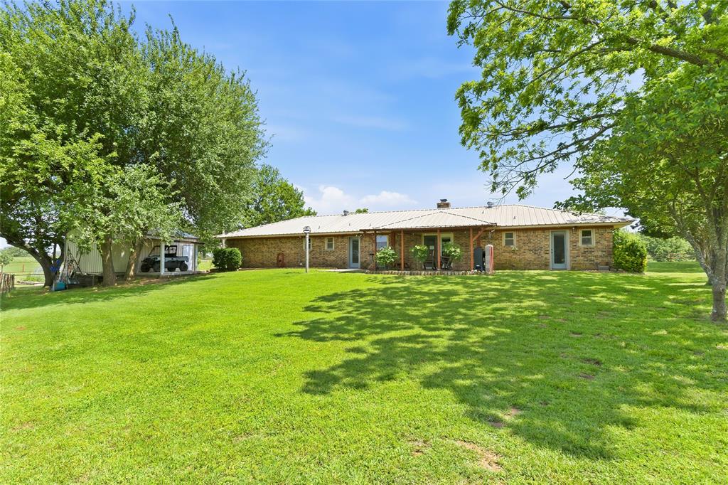 235 Magnus Road Denison, TX 75021 - Photo 29 of 35 a front view of a house with a garden