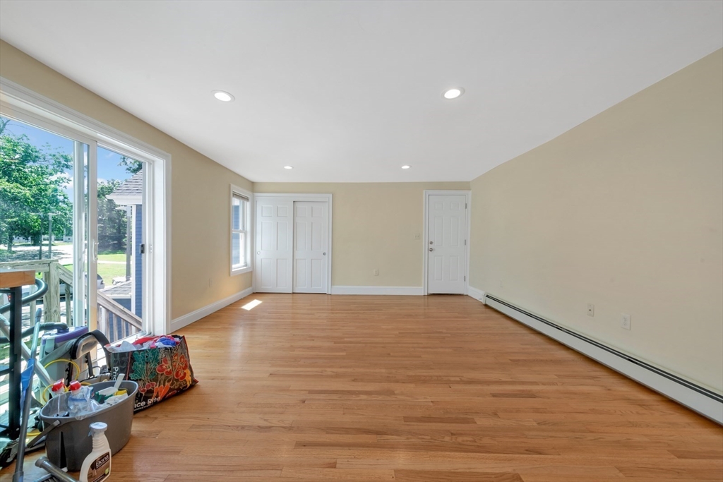 4 School Street, Unit 2 Boston, MA 02119 - Photo 18 of 25 a view of an empty room with wooden floor and a window