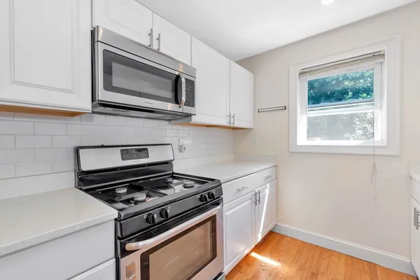 a kitchen with a stove and a microwave