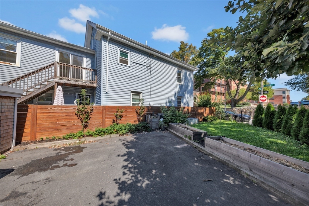 4 School Street, Unit 2 Boston, MA 02119 - Photo 5 of 25 a front view of a house with a yard and a garage