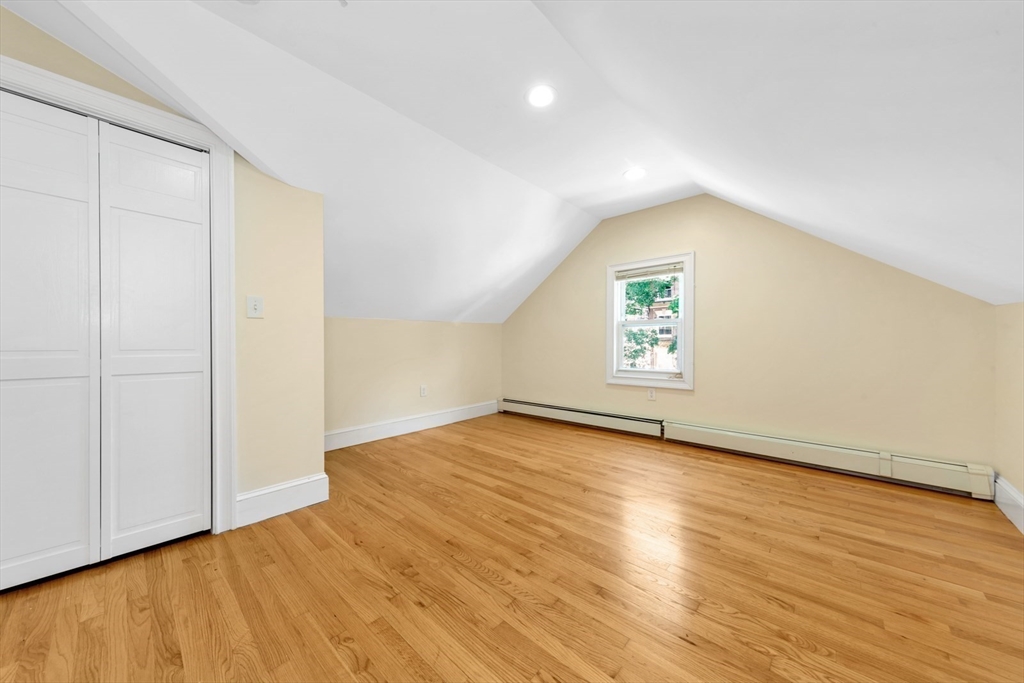 4 School Street, Unit 2 Boston, MA 02119 - Photo 9 of 25 an empty room with wooden floor and windows