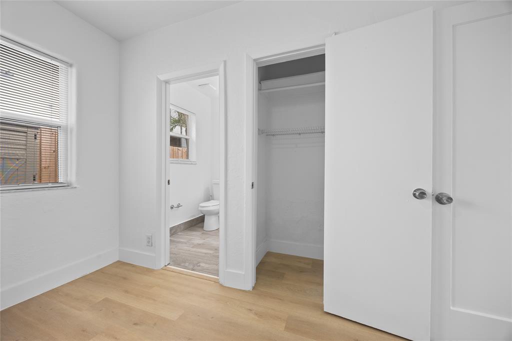 412 Southeast 16th Street, Unit 2 Fort Lauderdale, FL 33316 - Photo 11 of 20 a view of an empty room with wooden floor and a bathroom