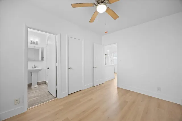 a view of a room with wooden floor and fan