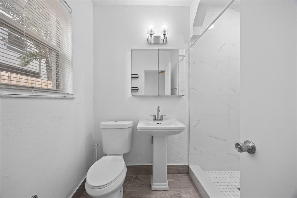 412 Southeast 16th Street, Unit 2 Fort Lauderdale, FL 33316 - Photo 13 of 20 a white toilet sitting next to a bathroom sink