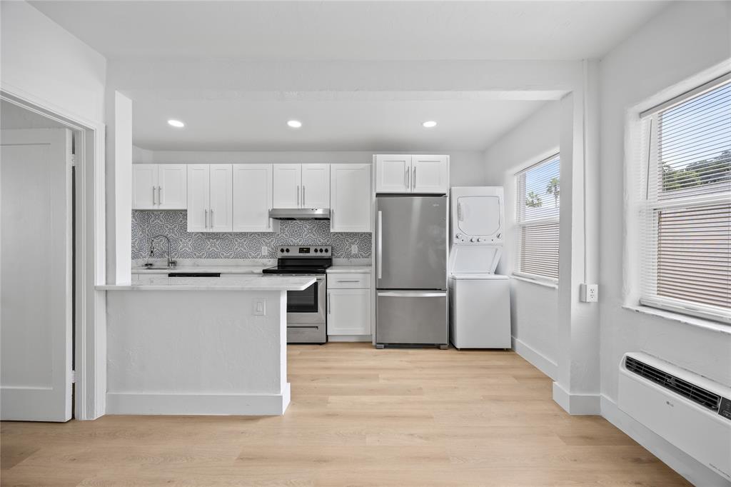 412 Southeast 16th Street, Unit 2 Fort Lauderdale, FL 33316 - Photo 2 of 20 a kitchen with a refrigerator a sink and cabinets