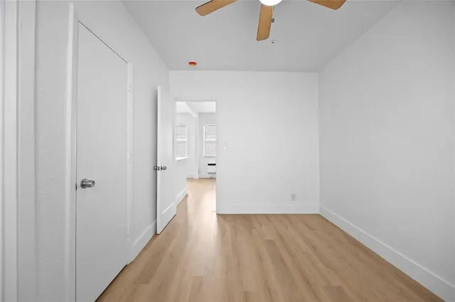 a view of a room with wooden floor and entryway