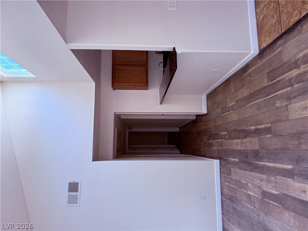 9325 West Desert Inn Road, Unit 260 Las Vegas, NV 89117 - Photo 3 of 42 Natural light streams into this versatile interior space with wood-look flooring.