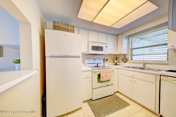 a kitchen with a sink a refrigerator and a stove