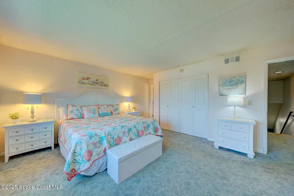a bedroom with a bed and a cabinets