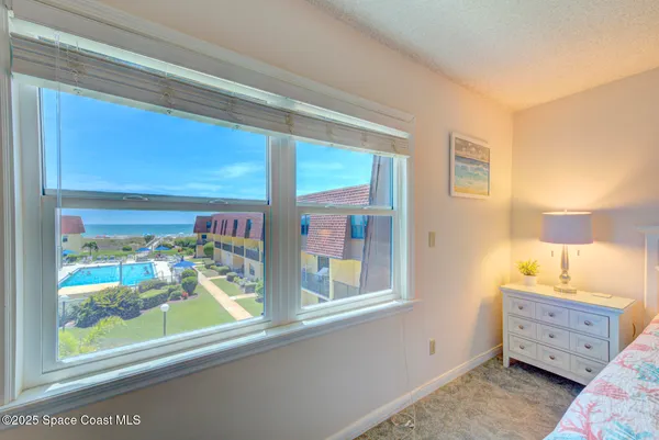 a view of a bedroom and a window