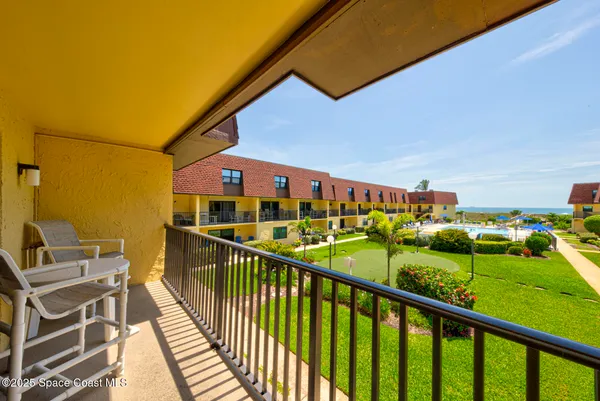 a view of a balcony with chairs