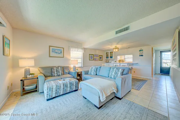 a spacious bedroom with two beds and painted walls