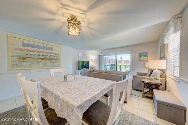 a view of a dining room with furniture and a window