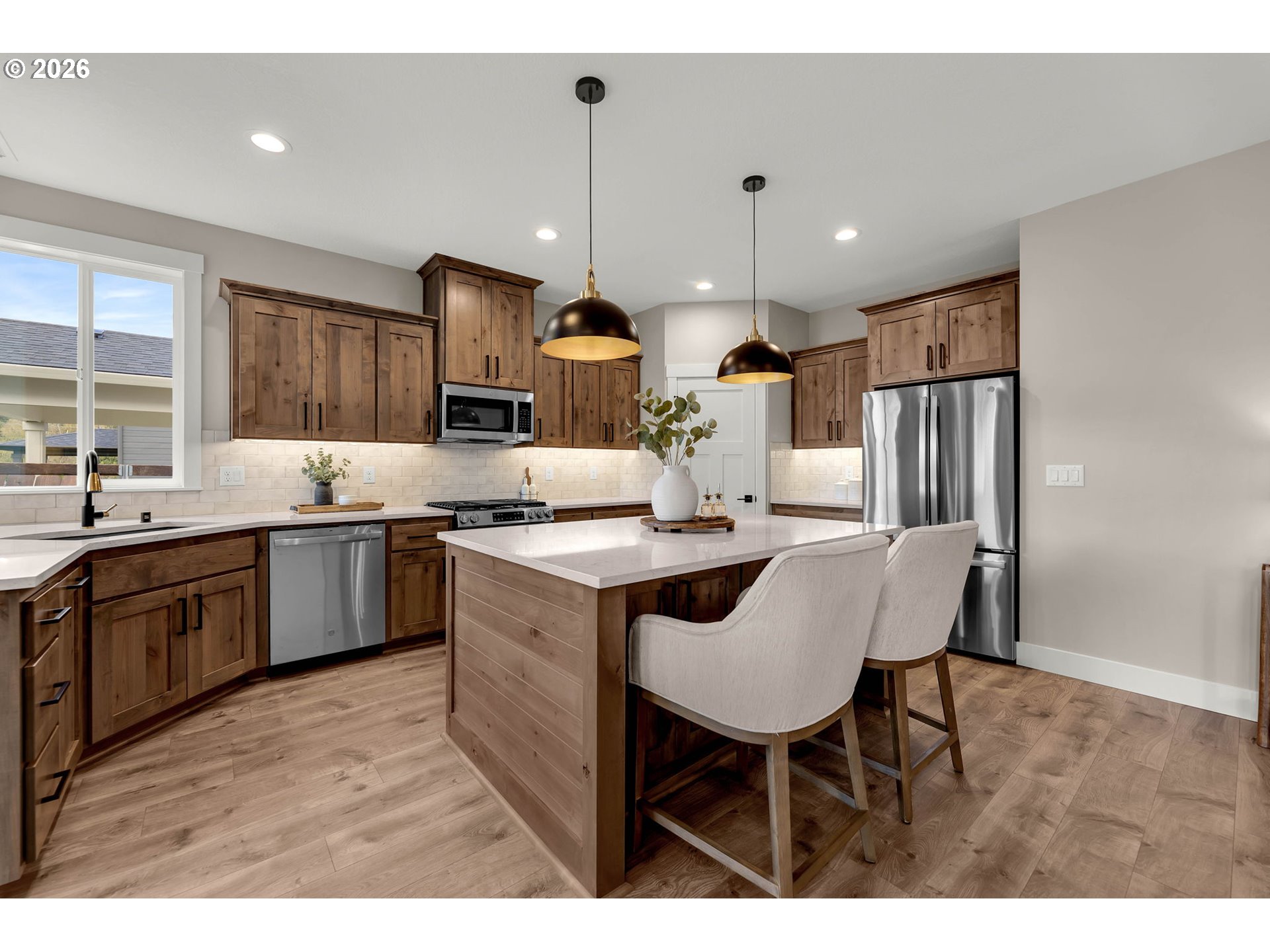 814 Southeast 35th Street Battle Ground, WA 98604 - Photo 14 of 37 a kitchen with stainless steel appliances kitchen island granite countertop a sink and a refrigerator