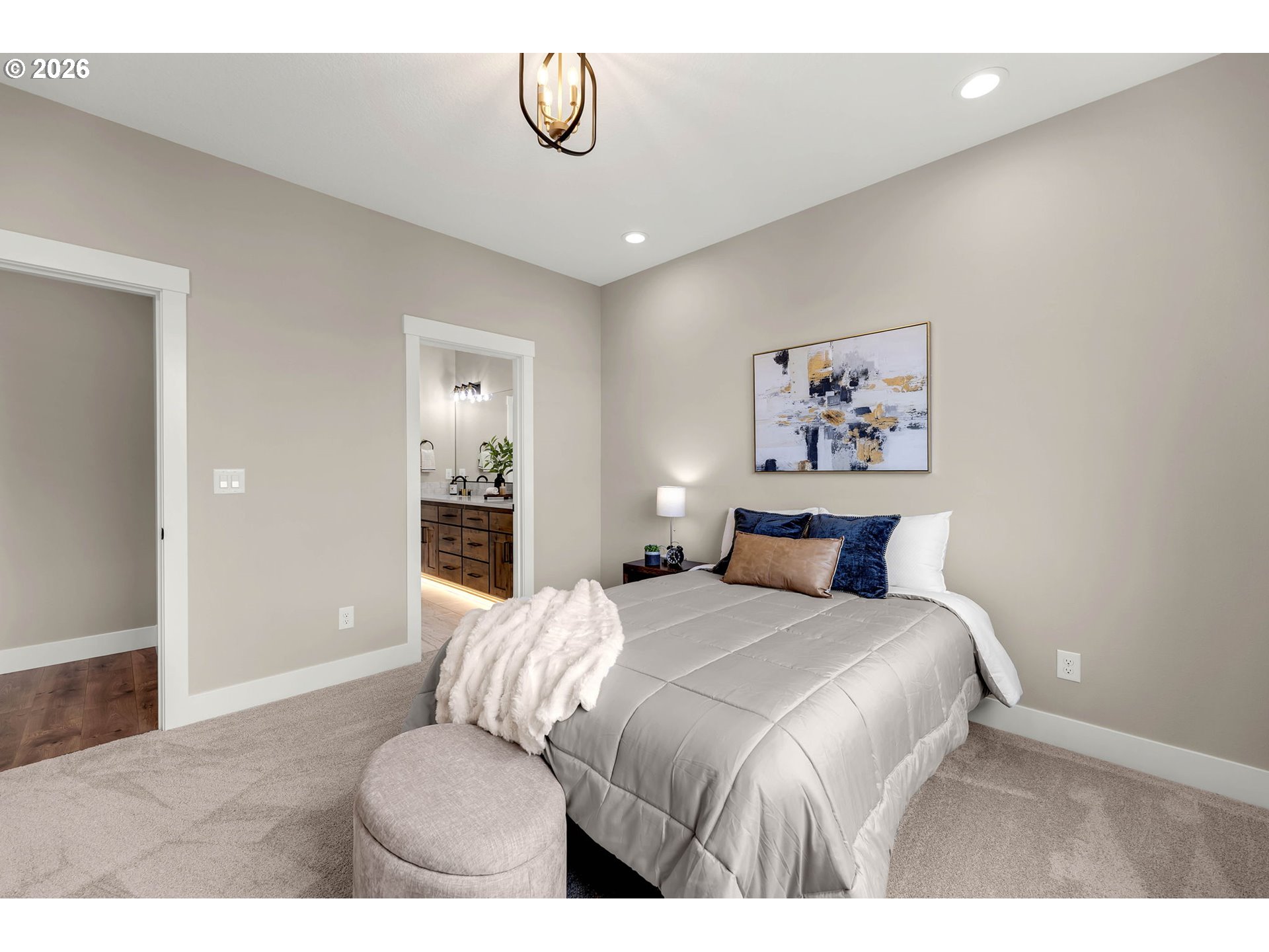 814 Southeast 35th Street Battle Ground, WA 98604 - Photo 31 of 37 a bedroom with a large bed and a chandelier