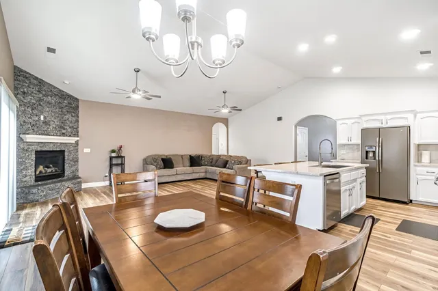 a large kitchen with a table and chairs