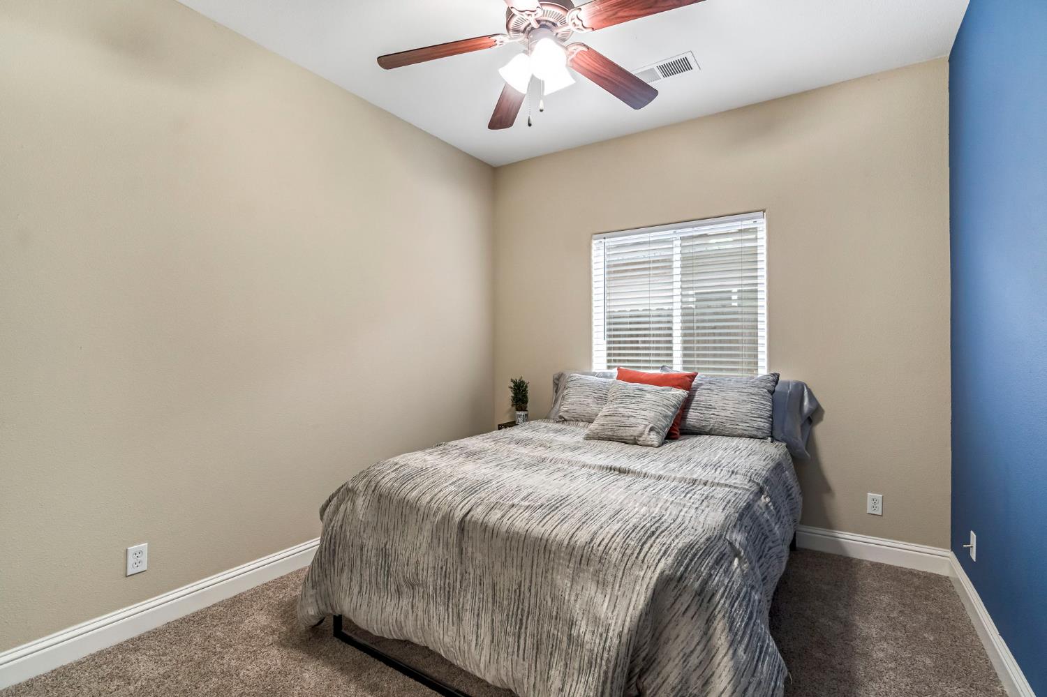 2634 Marie Drive Madera, CA 93637 - Photo 23 of 32 a bedroom with a bed and a chandelier