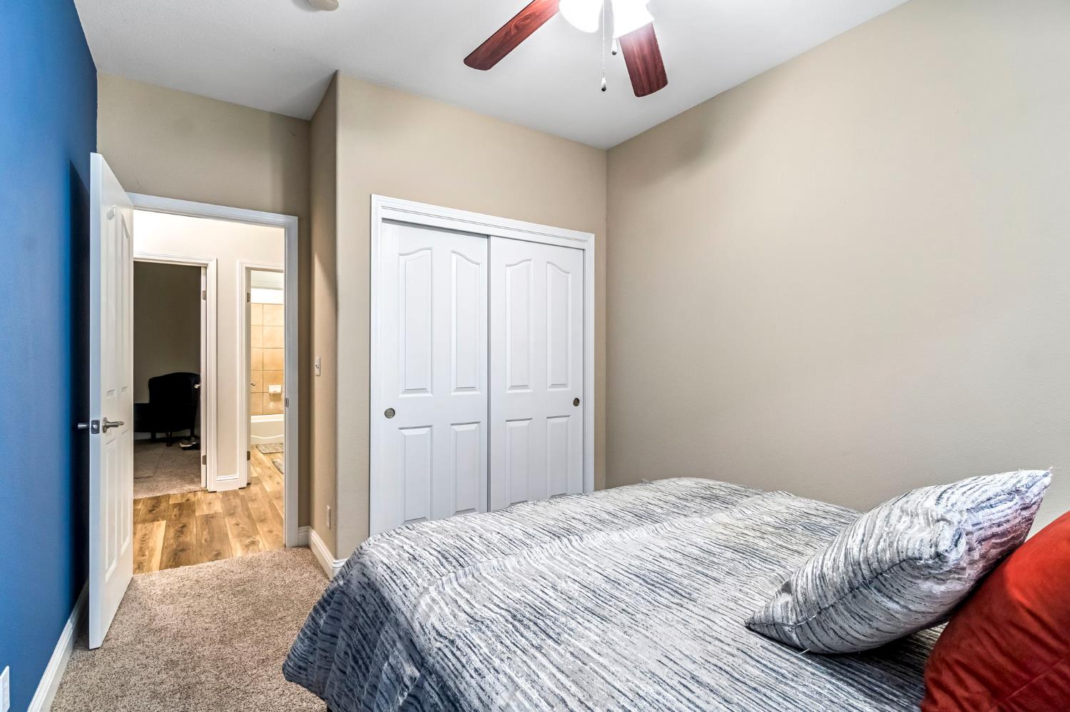 2634 Marie Drive Madera, CA 93637 - Photo 24 of 32 a bedroom with a bed and a chandelier