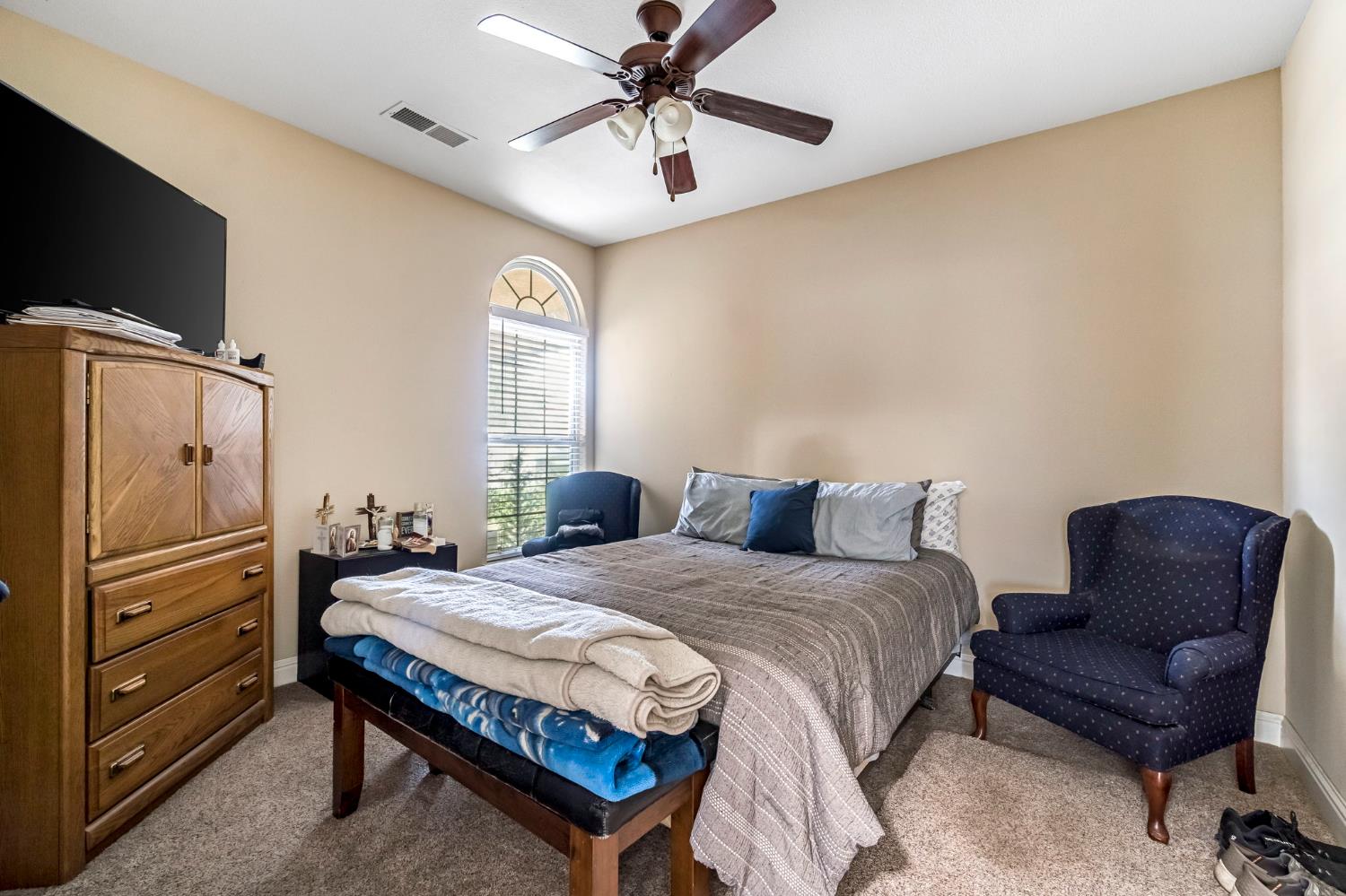 2634 Marie Drive Madera, CA 93637 - Photo 25 of 32 a bedroom with a bed and a flat screen tv