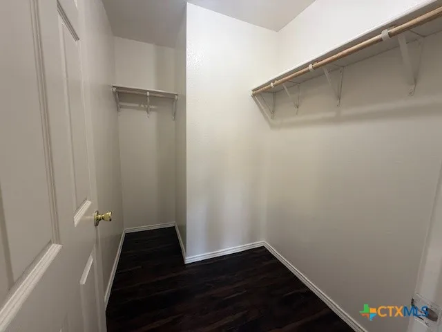 a view of small space with wooden floor and a ceiling fan