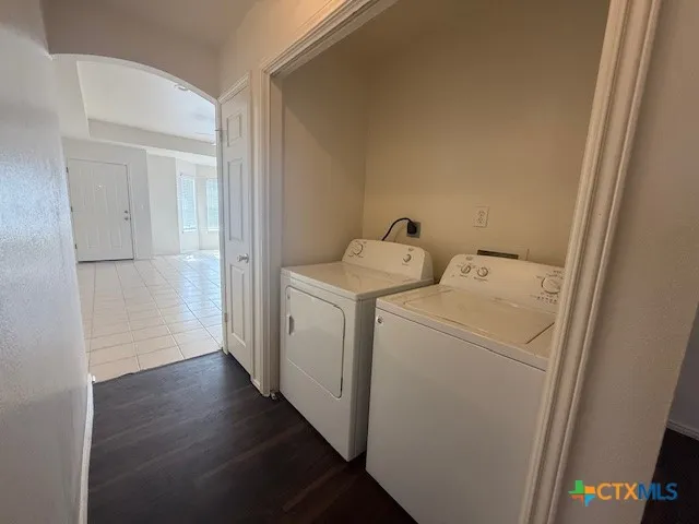 a view of storage and utility room with a washer dryer
