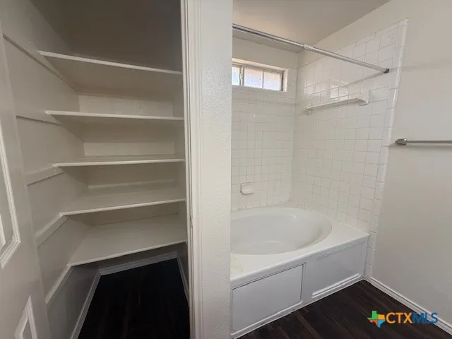 a white bath tub sitting next to a white tub