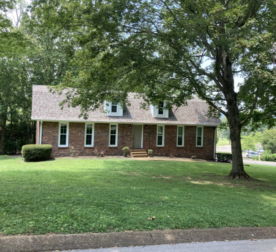 a front view of a house with a garden