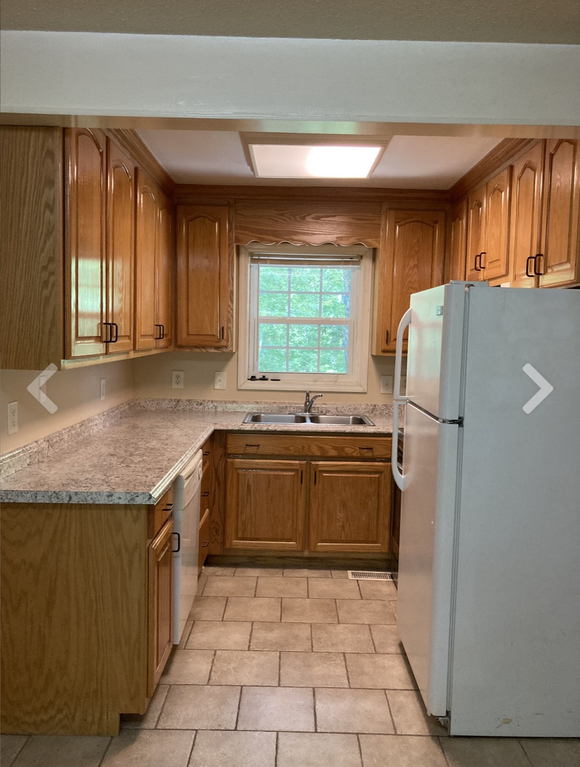 2202 Country Club Lane, Unit B Columbia, TN 38401 - Photo 2 of 6 a kitchen with a refrigerator a sink and a stove