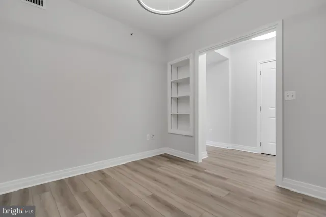 a view of room with wooden floor and window