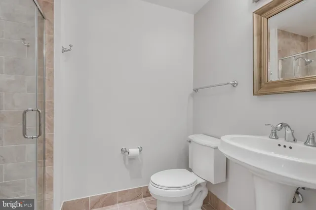 a white toilet sitting next to a bathroom sink