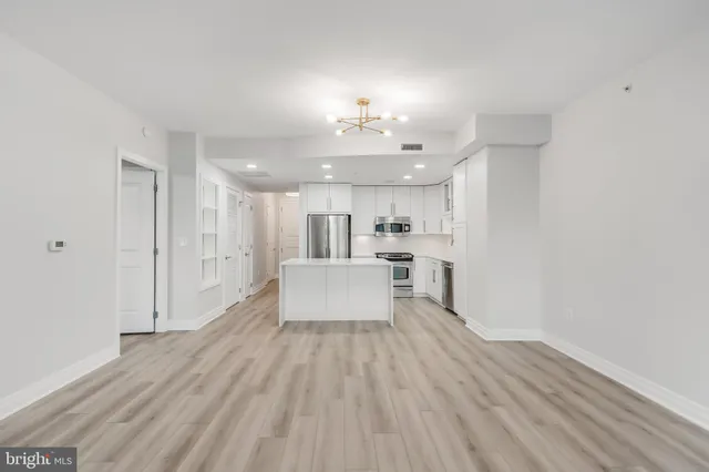 a view of kitchen with sink and refrigerator