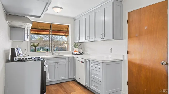 a kitchen with stainless steel appliances granite countertop a sink stove and cabinets
