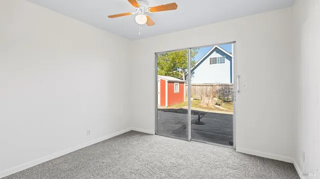 a view of kitchen with furniture and refrigerator
