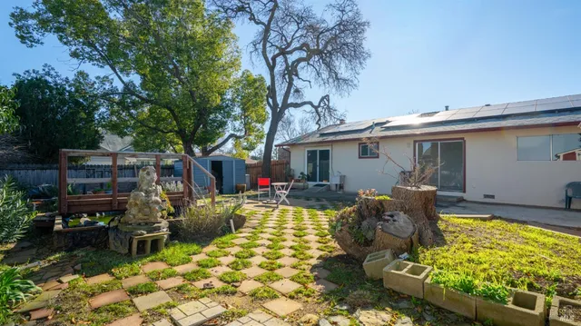 a front view of a house with a yard table and chairs